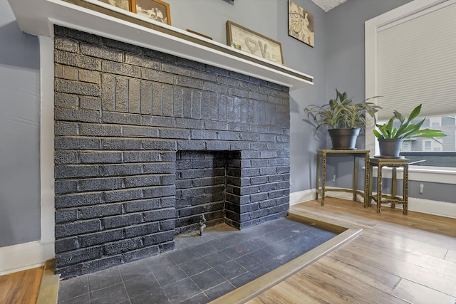 room details featuring hardwood / wood-style floors and a brick fireplace