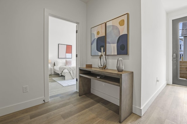 corridor with hardwood / wood-style floors