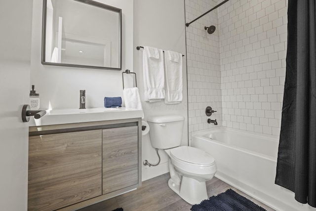 full bathroom with hardwood / wood-style floors, vanity, toilet, and shower / bath combination with curtain