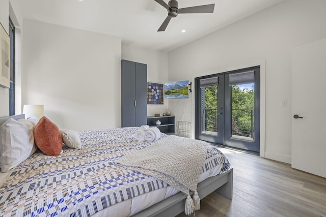 bedroom featuring french doors, access to outside, light hardwood / wood-style flooring, and ceiling fan