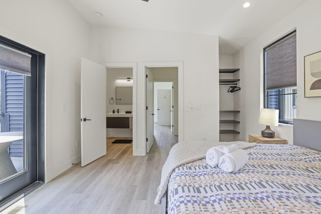 bedroom with light wood-type flooring and a closet