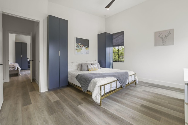 bedroom featuring hardwood / wood-style flooring and ceiling fan