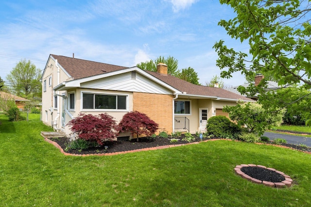 1677 Kenview Rd, Columbus, OH 43209 - view of front facade with a garage, a chimney, stucco siding, and a front lawn