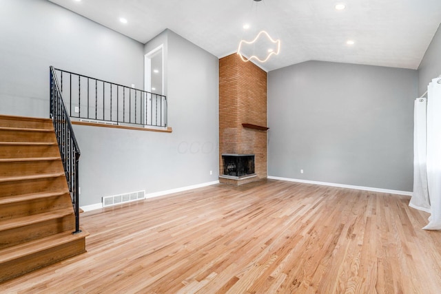 1677 Kenview Rd, Columbus, OH 43209 - unfurnished living room featuring an inviting chandelier, baseboards, wood finished floors, visible vents, and stairway