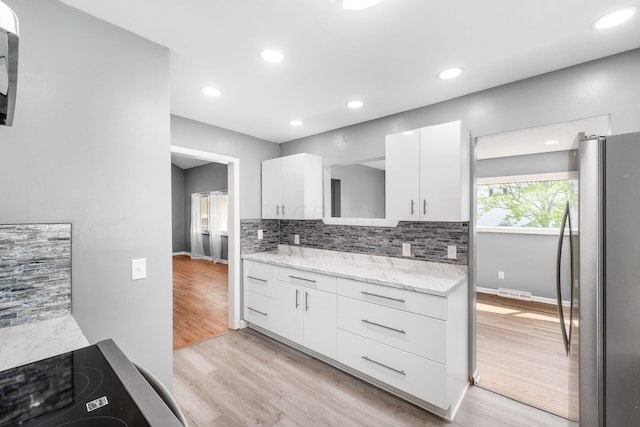1677 Kenview Rd, Columbus, OH 43209 - kitchen featuring freestanding refrigerator, light wood finished floors, white cabinets, and decorative backsplash