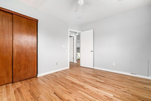 1677 Kenview Rd, Columbus, OH 43209 - unfurnished bedroom with a closet, baseboards, ceiling fan, and light wood-style floors