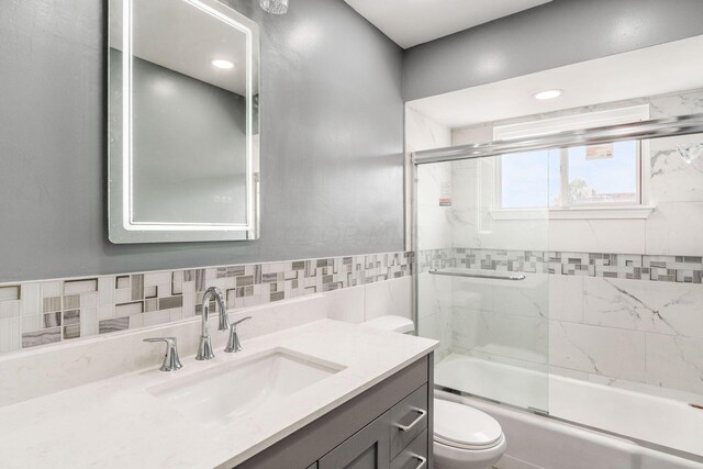 1677 Kenview Rd, Columbus, OH 43209 - full bath with toilet, tile walls, combined bath / shower with glass door, and vanity