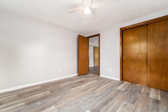 1677 Kenview Rd, Columbus, OH 43209 - unfurnished bedroom featuring baseboards, ceiling fan, wood finished floors, and a closet
