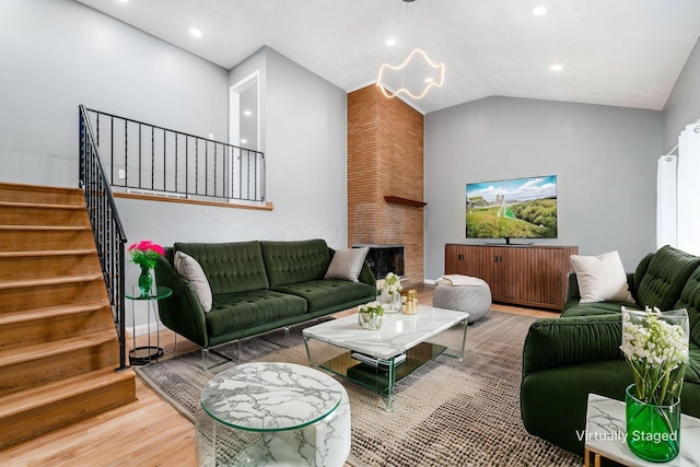 1677 Kenview Rd, Columbus, OH 43209 - living area with vaulted ceiling, wood finished floors, stairway, an inviting chandelier, and recessed lighting