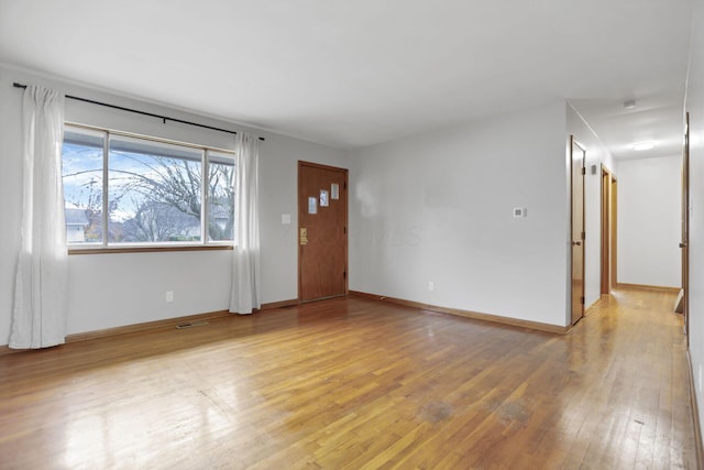 unfurnished living room with wood-type flooring