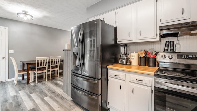 kitchen with white cabinets, a textured ceiling, stainless steel appliances, and light hardwood / wood-style floors