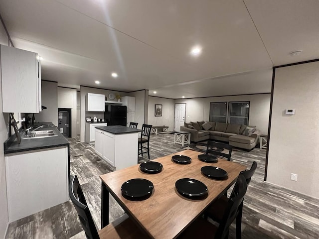 dining space featuring dark hardwood / wood-style floors and sink