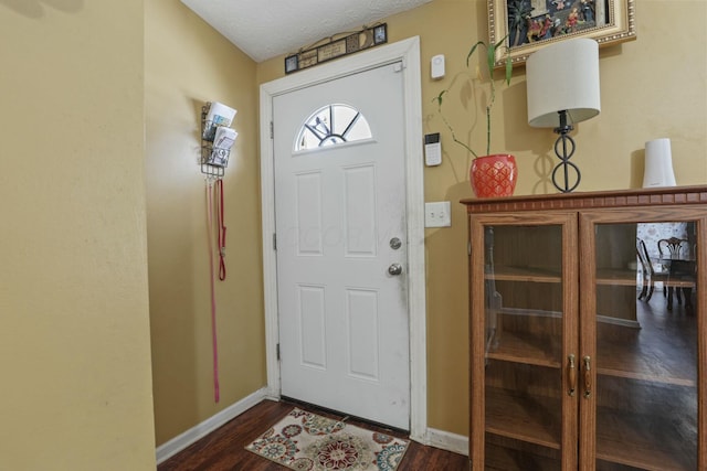 entrance foyer featuring dark hardwood / wood-style flooring and a textured ceiling