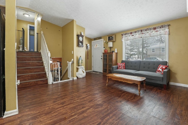 living room with dark hardwood / wood-style flooring and a textured ceiling