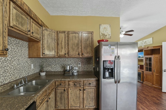 kitchen featuring decorative backsplash, dark hardwood / wood-style flooring, a textured ceiling, sink, and stainless steel fridge with ice dispenser