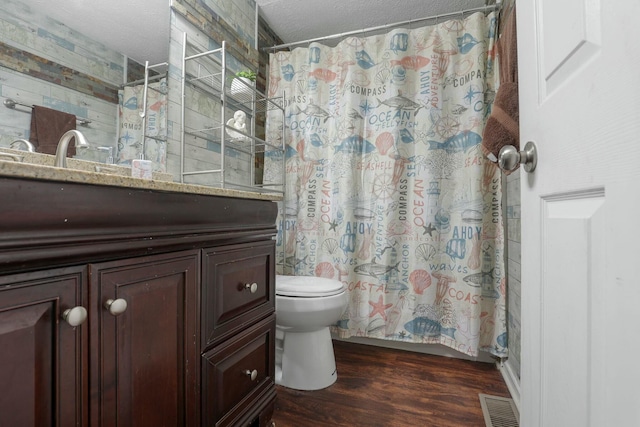 bathroom with hardwood / wood-style flooring, a textured ceiling, toilet, and shower / bath combo