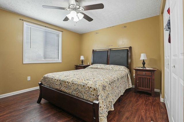 bedroom featuring ceiling fan, dark hardwood / wood-style floors, and a textured ceiling