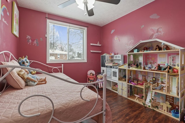 bedroom with ceiling fan, hardwood / wood-style floors, and a textured ceiling