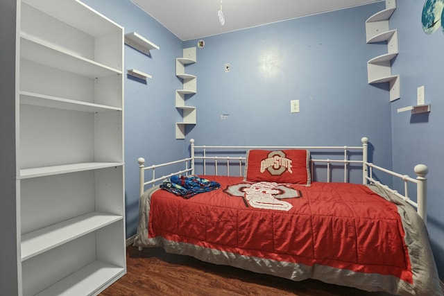 bedroom with dark wood-type flooring