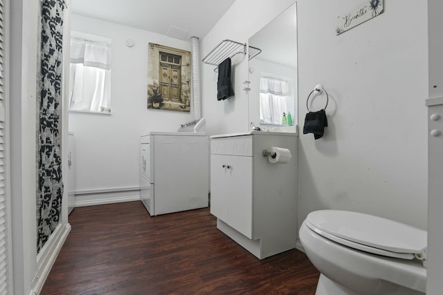 bathroom with vanity, wood-type flooring, washing machine and dryer, and toilet