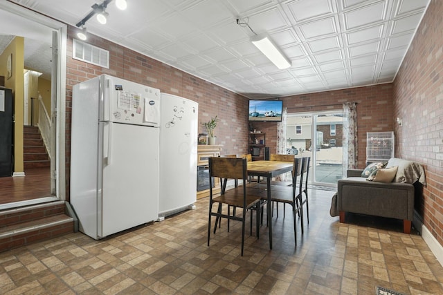 dining area with brick wall