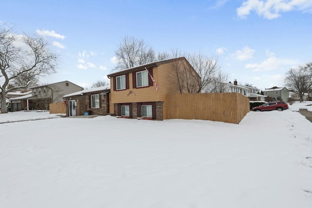 view of snow covered back of property