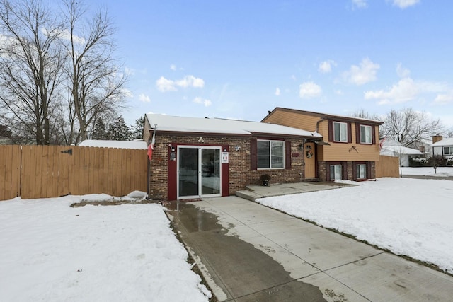 view of snow covered back of property