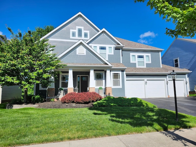 7201 Dean Farm Rd, New Albany, OH 43054 - craftsman house featuring a front yard, driveway, brick siding, a garage, and covered porch