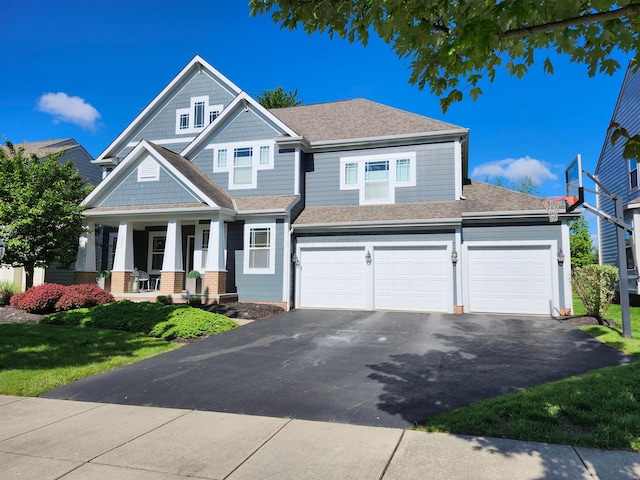 7201 Dean Farm Rd, New Albany, OH 43054 - view of front of house featuring driveway, a porch, roof with shingles, an attached garage, and a front lawn