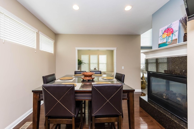 7201 Dean Farm Rd, New Albany, OH 43054 - dining space with a tiled fireplace, dark wood-type flooring, recessed lighting, and baseboards