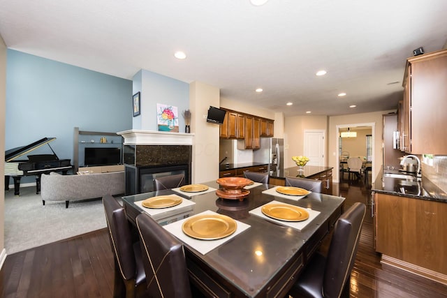 7201 Dean Farm Rd, New Albany, OH 43054 - dining space with dark wood-style floors, recessed lighting, and a tiled fireplace