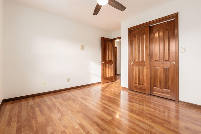 unfurnished bedroom featuring ceiling fan, a closet, and light wood-type flooring