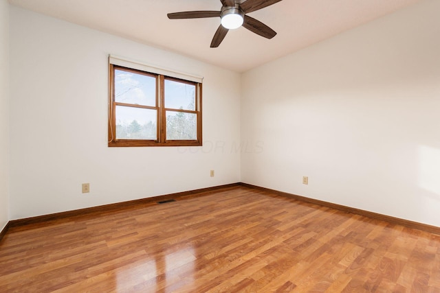 spare room featuring light wood-type flooring and ceiling fan