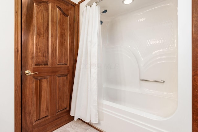 bathroom featuring tile patterned floors and shower / bathtub combination with curtain