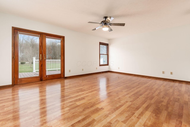 empty room featuring a wealth of natural light, french doors, ceiling fan, and light hardwood / wood-style floors