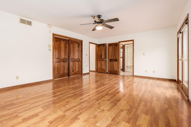 interior space with multiple windows, light wood-type flooring, and ceiling fan