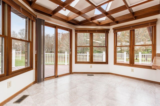 unfurnished sunroom with beam ceiling and coffered ceiling