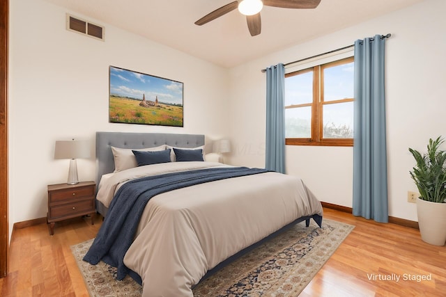 bedroom with ceiling fan and wood-type flooring