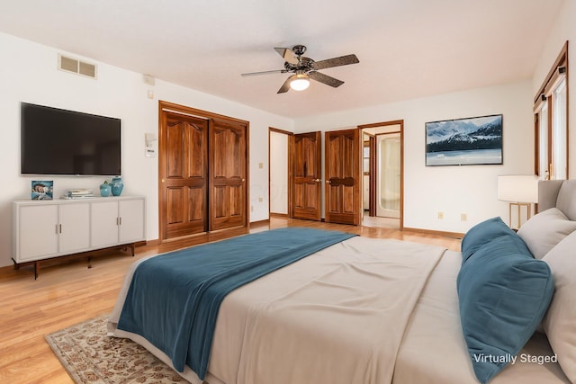 bedroom with light hardwood / wood-style floors and ceiling fan