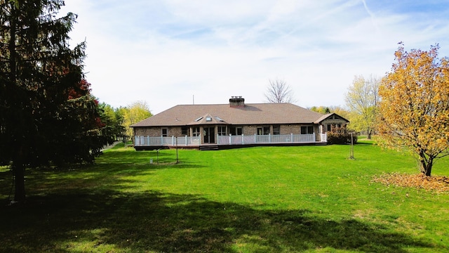 back of property featuring a lawn