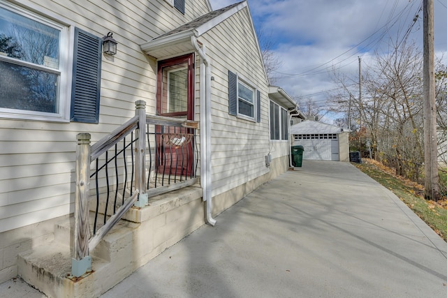 view of side of home featuring an outbuilding and a garage