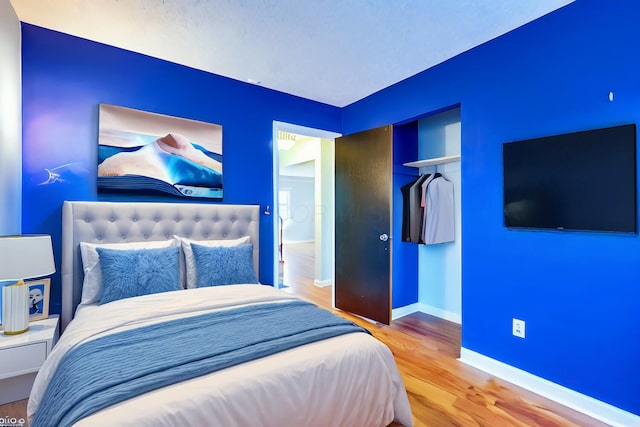 bedroom with hardwood / wood-style flooring and a closet