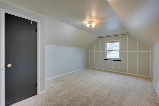 bonus room featuring light colored carpet and lofted ceiling