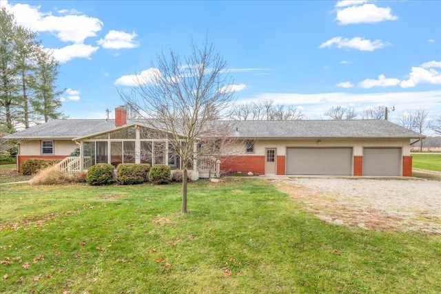 ranch-style home with a sunroom, a garage, and a front lawn