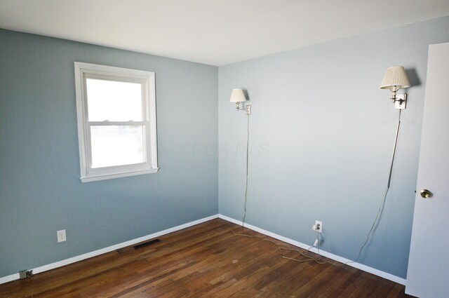 unfurnished room featuring dark hardwood / wood-style floors