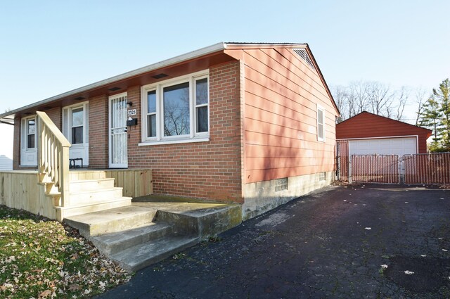 view of front facade with a garage and an outdoor structure