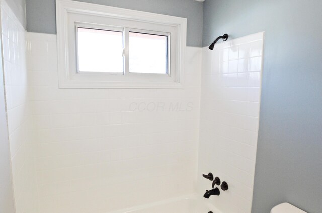 bathroom featuring toilet and shower / washtub combination