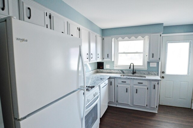 kitchen featuring white cabinets, white appliances, sink, and dark wood-type flooring