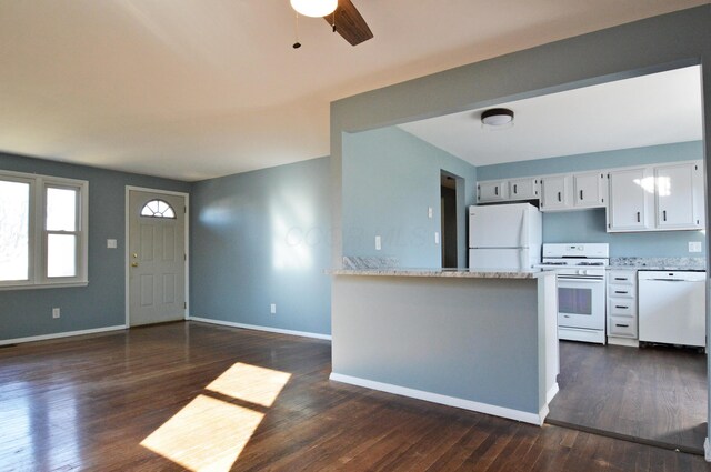 kitchen featuring kitchen peninsula, white appliances, ceiling fan, dark wood-type flooring, and white cabinetry