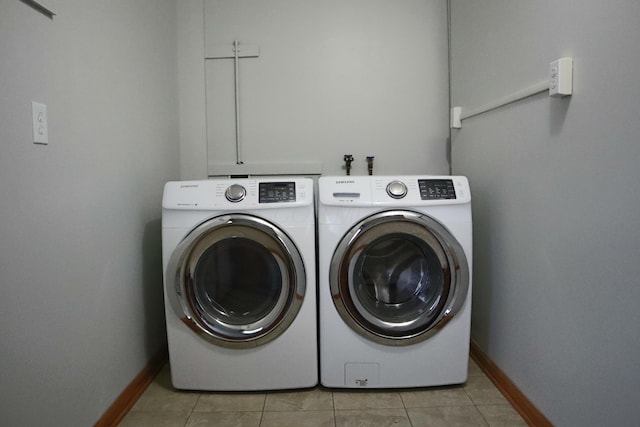 laundry room featuring washer and dryer and light tile patterned floors